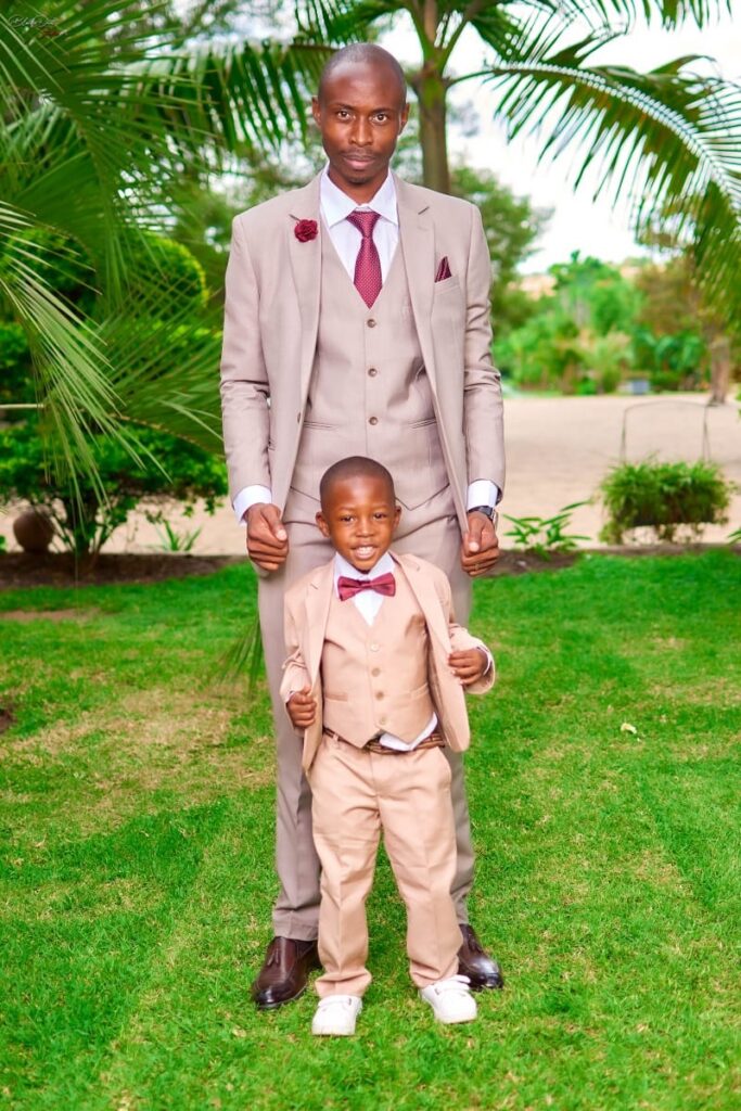 Groom and Paige boy wearing nude champagne suits from Minnie Bridal Boutique at a wedding in Harare - Zimbabwe Wedding Groom and groomsmen suits for sale - Zimbabwe wedding planner - Featured Vendor Fridays - Wedding Expos Africa 