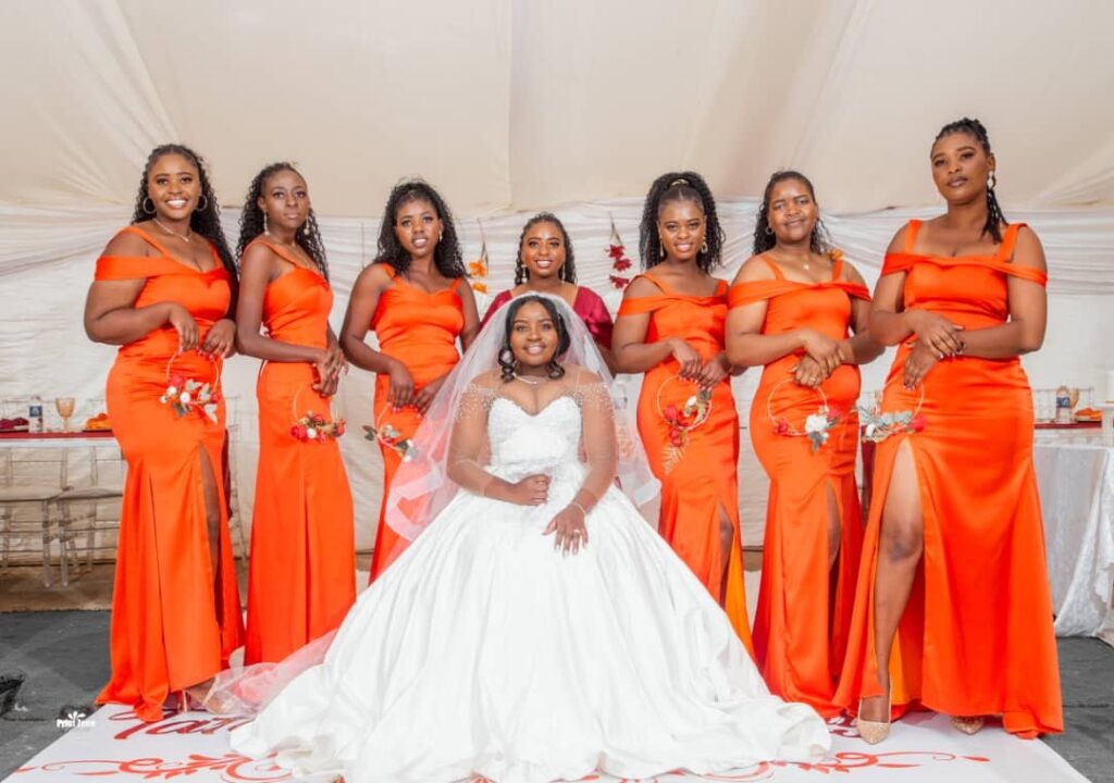 Bride in a white ball gown wedding dress and her Bridesmaids wearing orange bridesmaids dresses from Minnie Bridal Boutique at a wedding in Harare - Zimbabwe Wedding Dress for sale - Zimbabwe wedding planner - Featured Vendor Fridays - Wedding Expos Africa 